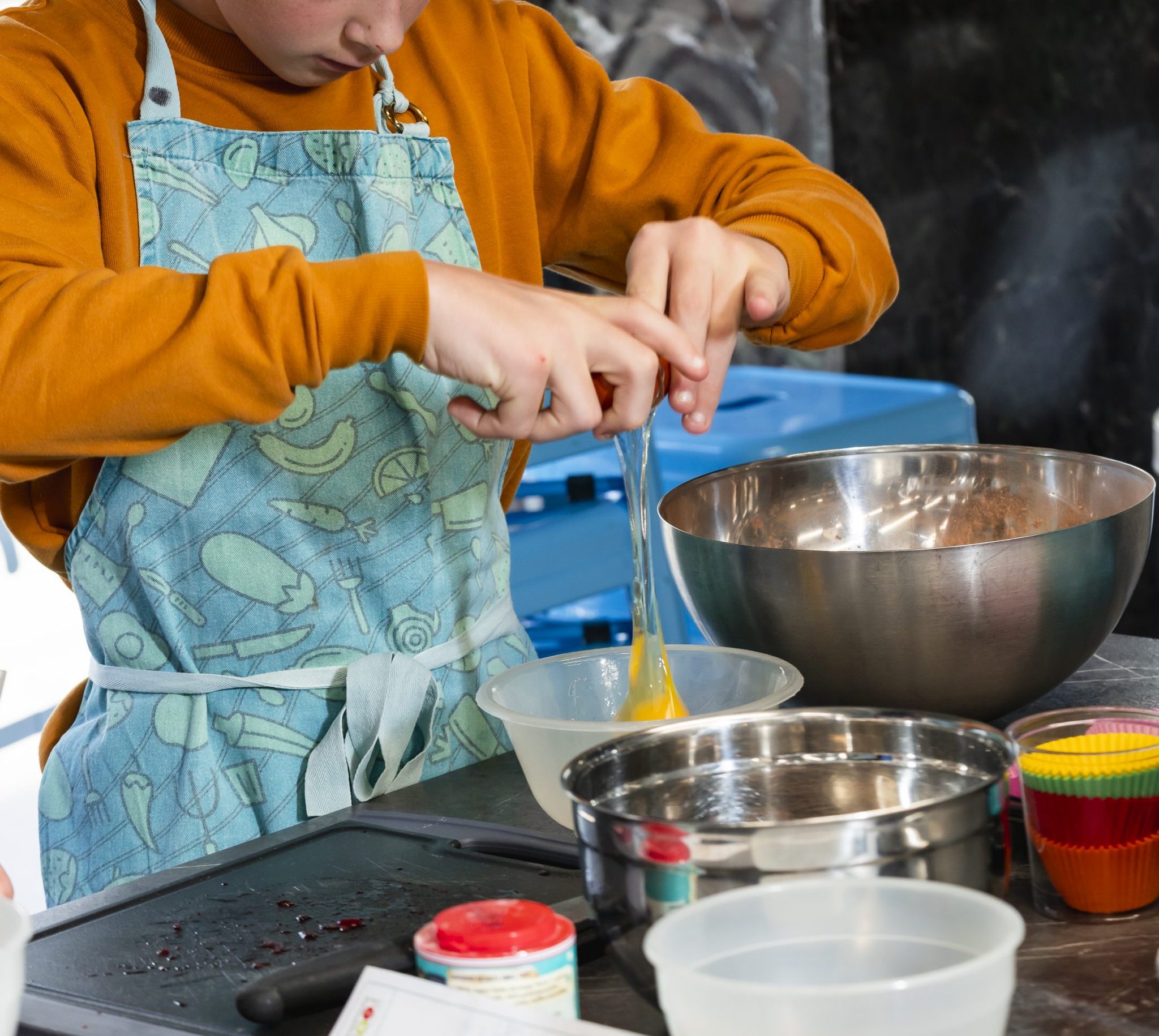 child cracking an egg